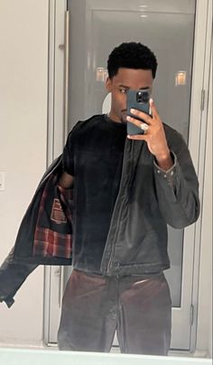 a man taking a selfie in front of a mirror