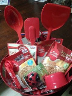 a red basket filled with lots of food and utensils