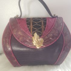 Gorgeous Unique From The 80s, Embossed Reptile Leaves Pattern. Leave Clasp Is Definitely Unique With Leather Both Sides Of Bag. This Bag Is In Excellent Condition For A 40+Years Old With 1 Small Callout Inside And Nothing Noticeable Outside. Purple, Dark Green And Bit Of Brown. Stunning Purple Shoulder Bag With Detachable Handle For Evening, Purple Evening Shoulder Bag With Detachable Handle, Evening Purple Shoulder Bag With Detachable Handle, Retro Burgundy Formal Bag, Retro Burgundy Formal Bags, Formal Retro Burgundy Bag, Purple Evening Shoulder Bag, Vintage Purple Bags For Formal Occasions, Vintage Purple Bag For Everyday Use