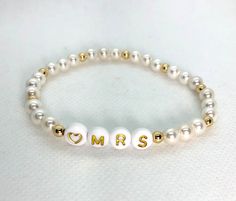 "This listing is for ONE custom heishi bead bracelet.  (See bridal stack listing if you're wanting all three: https://etsy.me/3b200dN) Use drop down to select pearl or colors. You'll use the personalization box to let me know if you're choosing the Mrs. or the Bride. NOTE If you're ordering more than 1 you'll need to add each bracelet to the cart separately with notes for that particular bracelet. (Message me if you're wanting some \"bride tribe\" bracelets to go with it.) These are stretch brac Bride Tribe Bracelet, Bridal Stack, Letter Bead Bracelet, Heishi Bead Bracelet, Bracelets Stack, Bracelet Message, Letter Bead Bracelets, Bride Bracelet, Perfect Gift For Girlfriend