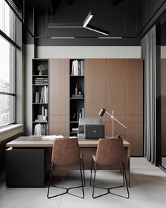 two brown chairs sitting in front of a wooden desk