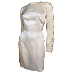 A beautiful pale yellow silk dress from Pierre Balmain. It is semi fitted skimming the body with a crew neckline and long sleeves adorned along the outside with dozens of silver safety pins of varying sizes. The dress strikes a deconstructed note with raw edges along the arms and sides. It is unlined but meticulously finished on the inside and has a back zipper. Fits sizes Small, Medium. Bust 36" Waist 30" Hips 40" Sleeves 24" Shoulders 14.50" Length 36" Safety Pin Dress, Greek Style Dress, Yellow Silk Dress, Pin Dress, Silk Yellow Dress, Bandage Dress Black, Velvet Cocktail Dress, Slim Aarons, Afternoon Dress