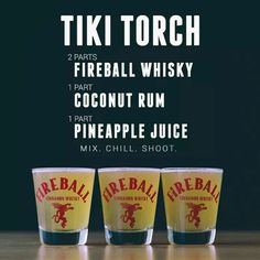 three shot glasses sitting next to each other on top of a wooden table with the words tiki torch