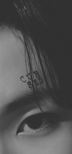 a close up of a person's face with writing on their forehead