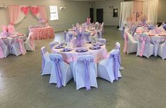 tables and chairs are set up for a wedding reception with pink and purple sashes