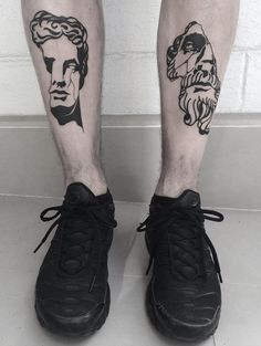 a man's legs with black and white tattoos on them