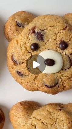 cookies with chocolate chips and a teddy bear made out of cookie doughnuts are on a white surface