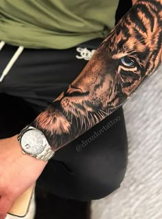 a man with a tiger tattoo on his arm