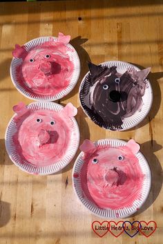 three paper plates with pigs on them sitting on a table