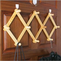 three wooden pegs are hanging on the door