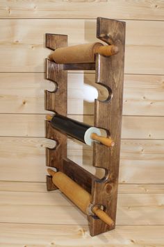 a wine rack made out of wood with several bottles in it and two corks sticking out of the top