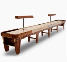 a long wooden table with two benches on it's sides and one bench at the end