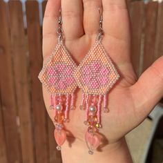 Hand beaded pink and peach earrings with flower design and pink dangle pieces Elegant Pink Flower Beaded Earrings, Pink Dangle Flower Earrings With Colorful Beads, Pink Dangle Flower Earrings, Beaded Fuschia Flower Earrings, Handmade Pink Flower-shaped Earrings, Peach Earrings, Beautiful Beaded Earring, Hand Beading, Heart Earrings