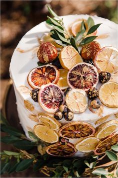 a cake with oranges and other fruits on it