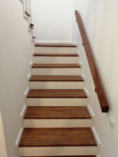 a set of wooden stairs leading up to a second floor