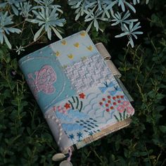 a small notebook is hanging from a tree