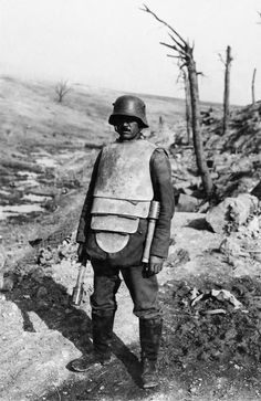 Libanorojo • 29 weeks ago A German member of a "Trench Attack Squad" poses in steel body armor and two stick grenades. The armor, capable of stopping a pistol round but only superficially helpful against rifle fire, also helped protecting against bayonet and other edged weapons thrusts. The additional weight though fatigued the wearer quickly and defeated any tactical advantage he might have wearing it. Modern World History, Battle Of The Somme, Historia Universal, Military Soldiers, Military Gear, German Army, Military History, World History