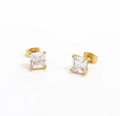 These chic yet classy earrings are a must have for our jewelry box. Features a 5mm x 8mm CZ solitaire stone that can be stacked or worn solo for that elegant look. Add a few HOJM huggies or chain link necklaces for the perfect eye-catching glance. Material: Gold Plated over Stainless Steel base with CZ stones. Tarnish and Water Resistant. Allergies: Hypoallergenic Classic Earrings With Diamond Eyes For Gift, Classic Gold Earrings With Diamond Eyes, Classic Gold Jewelry With Diamond Eyes, Minimalist Jewelry With Diamond Eyes For Anniversary, Classy Earrings, Sunglass Chain, Solitaire Studs, Perfect Eyes, Earring Sale