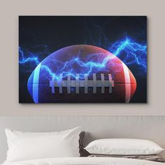 an american football with lightning in the background on a wall above a bed and pillows