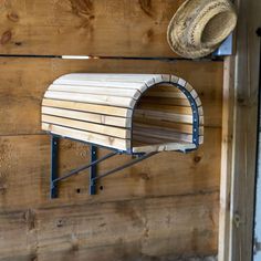 a wooden wall with a mailbox and hat hanging on it's back side