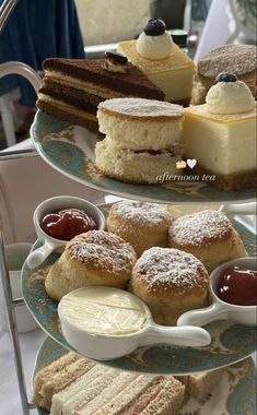 three tiered trays filled with different types of desserts and confections