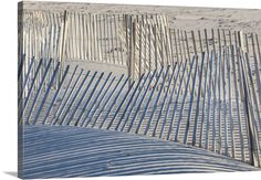 the sand dunes are lined with wooden slats