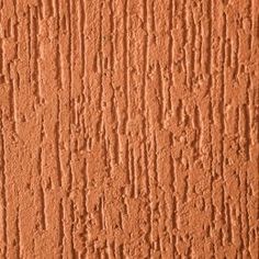 an orange painted wall with small cracks in it's paint chippings on the surface