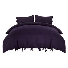 an image of a bed with purple sheets and pillow cases on it's side