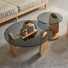 two glass tables sitting on top of a rug