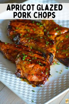 grilled pork chops on a white plate with parsley