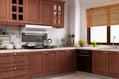 a kitchen with wooden cabinets and marble counter tops