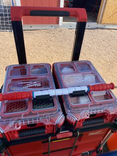 two red and clear plastic containers sitting on top of a cart