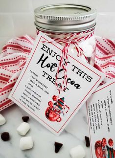 a jar filled with marshmallows next to a card