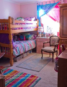 a bedroom with two bunk beds and a chair