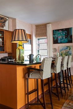 a kitchen with wooden cabinets and bar stools