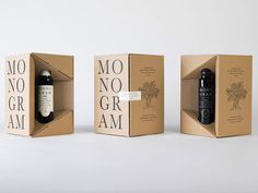 three boxes with wine bottles in them sitting next to each other on a white surface