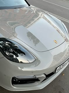 a silver sports car parked on the side of the road