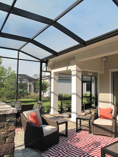 a covered patio with chairs and tables on it