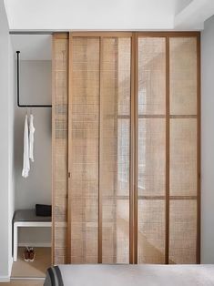 a bedroom with wooden sliding doors and white walls