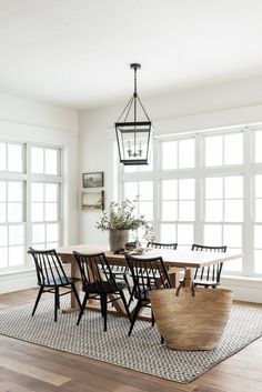 the dining room table and chairs are all in different styles, but one is black