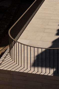 a man riding a skateboard down the side of a metal hand rail