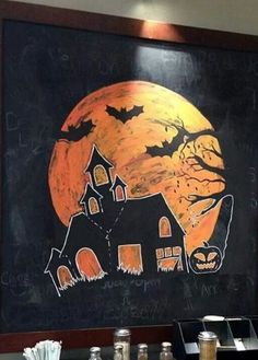 an image of a halloween themed restaurant with pumpkins on the table and bats painted on the wall