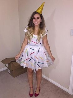 a woman wearing a birthday hat and dress with sprinkles on the skirt