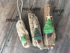 three pieces of driftwood with christmas trees on them