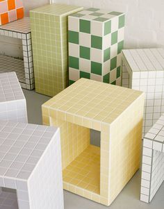 there are many different colored cubes on the floor in front of a white wall