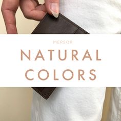 a person holding a wallet with the words, natural colors