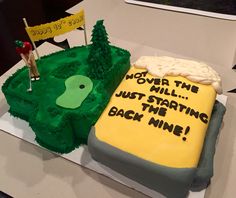 a golf themed cake on a table with a flag and yellow sign that says, not over the hill just starting the back nine