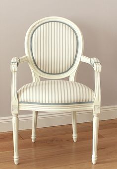 a white chair sitting on top of a hard wood floor