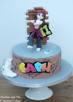 a birthday cake with a girl holding a sign