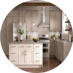 a white kitchen with beige cabinets and wood flooring in the center is seen through a circular hole